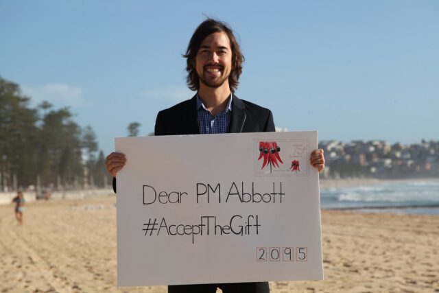 Jody Lightfoot on Manly Beach as Common Grace ask PM Tony Abbott to #acceptthegift of solar for Kirribilli House
